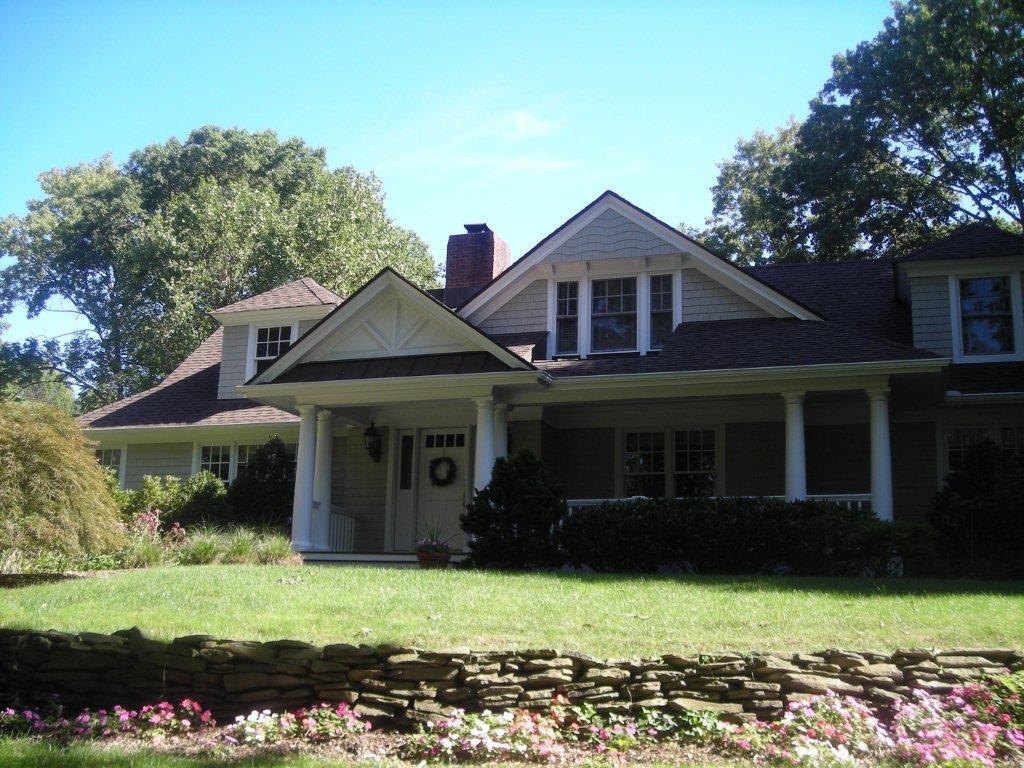 A large house with a lot of flowers in front