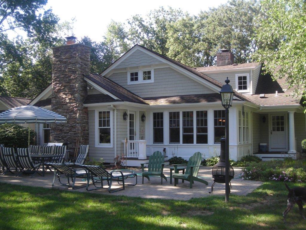 A large house with many chairs outside of it