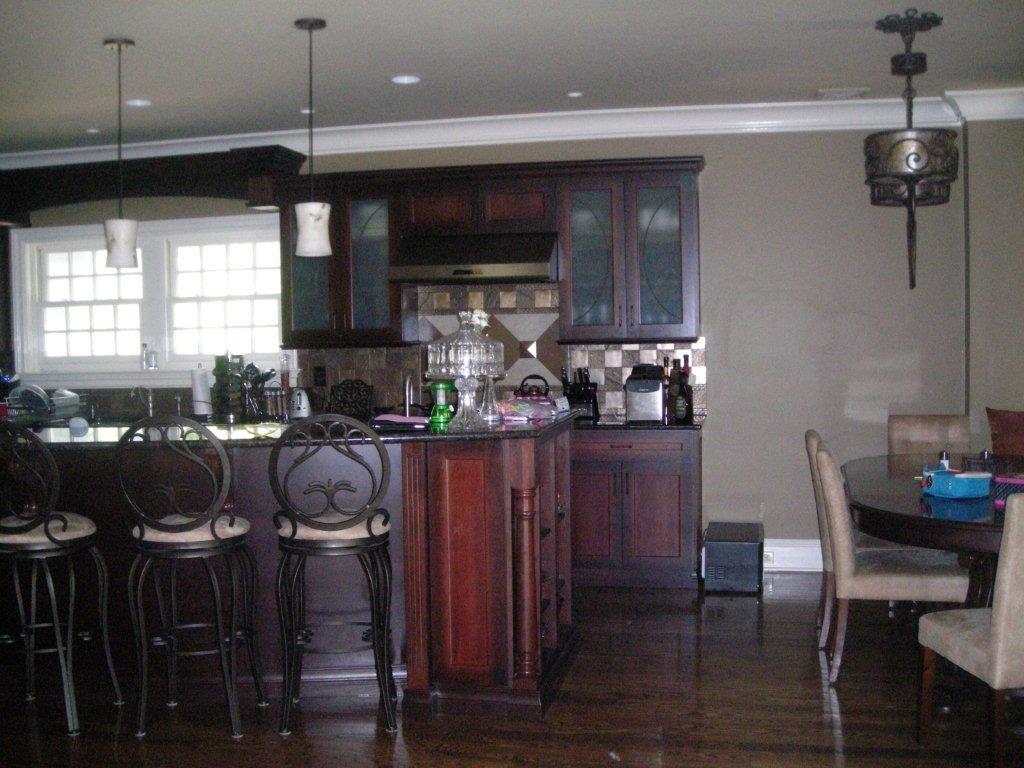 A kitchen with a dining table and chairs