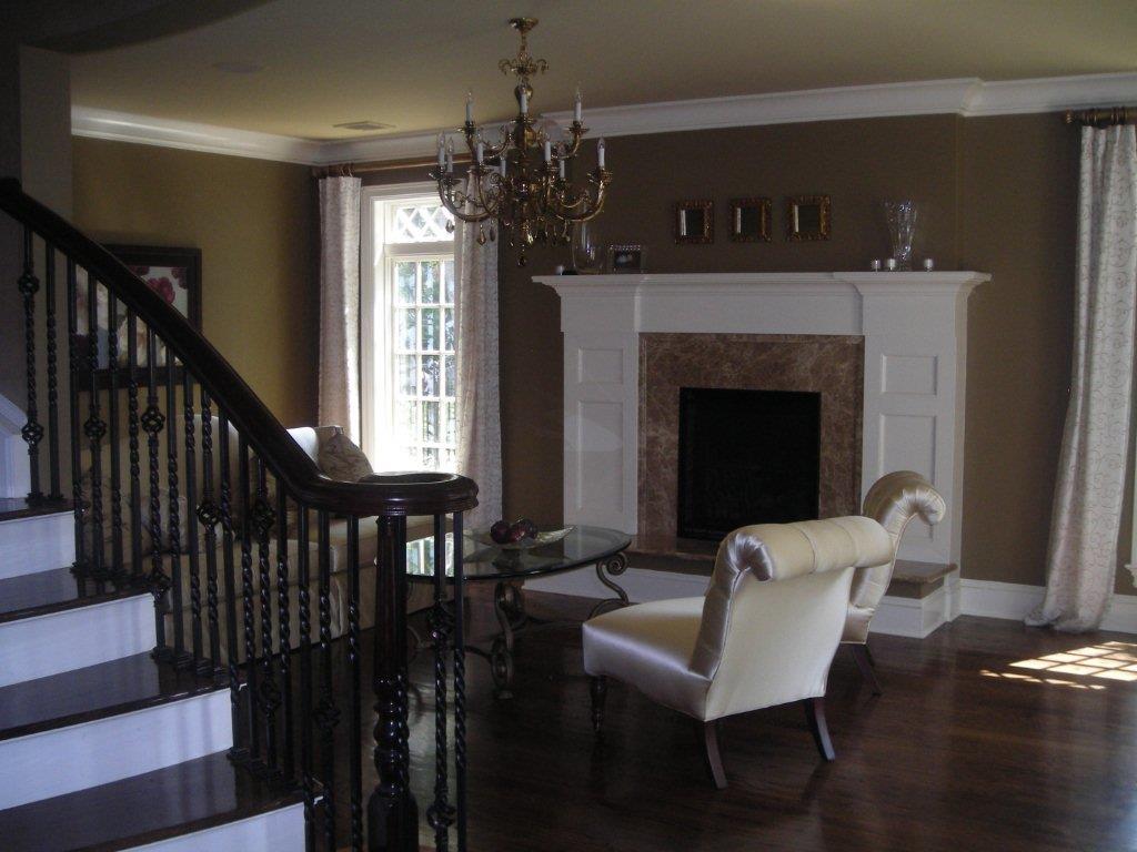 A living room with a fireplace and stairs