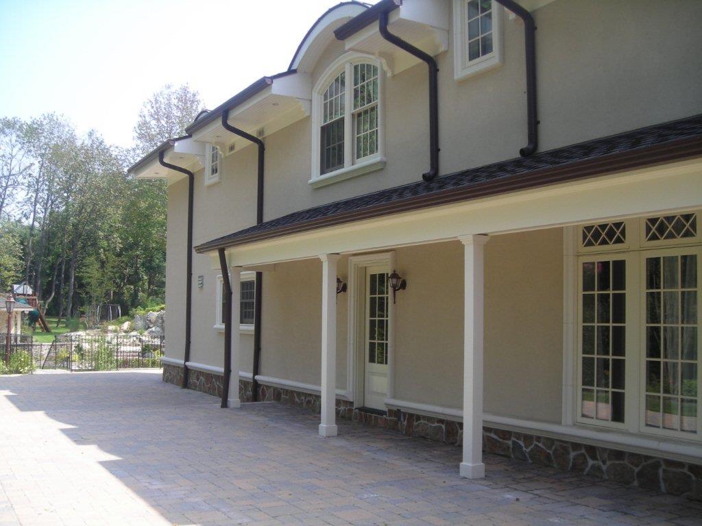 A large house with a porch and patio area.