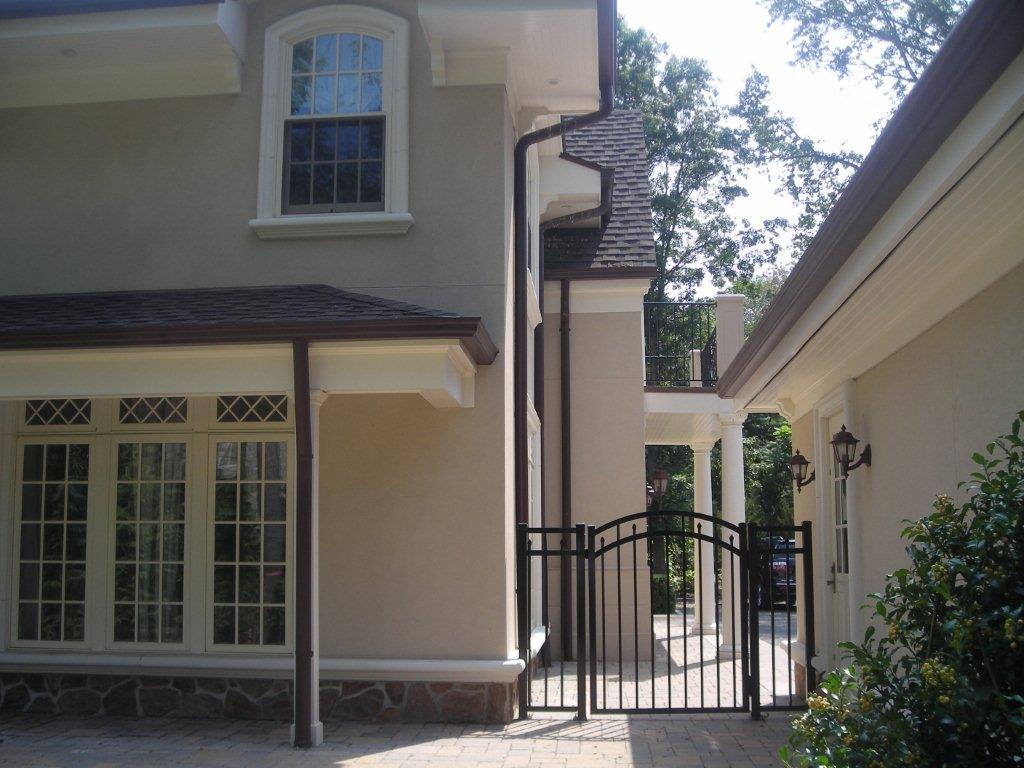 A house with a gate and fence in front of it