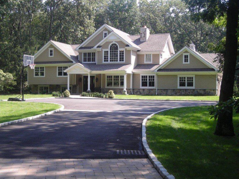 A large house with a driveway in front of it.