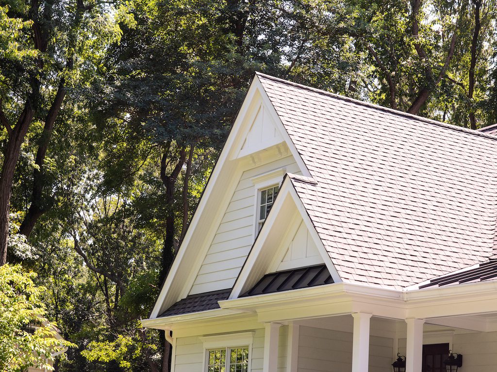 A white house with a roof and windows.