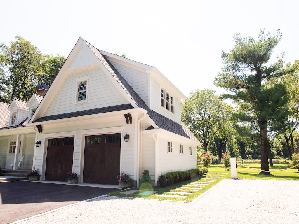 A white garage with two doors and a driveway.