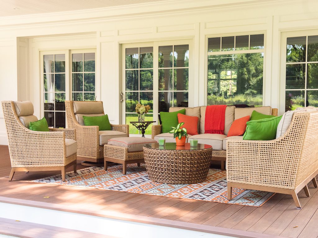 A patio with several chairs and tables in it.